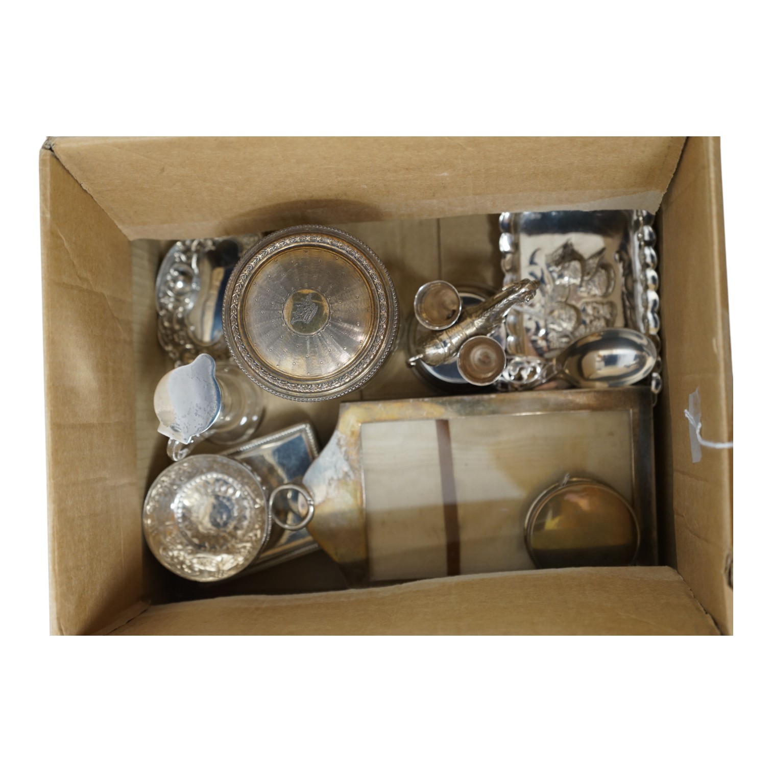 Assorted small silver including a small Reynolds Angels pin tray, Birmingham, 1900, 11.1cm, one other small dish, a modern mounted timepiece, a French mounted glass salts bottle, a photograph frame, a mounted glass whisk